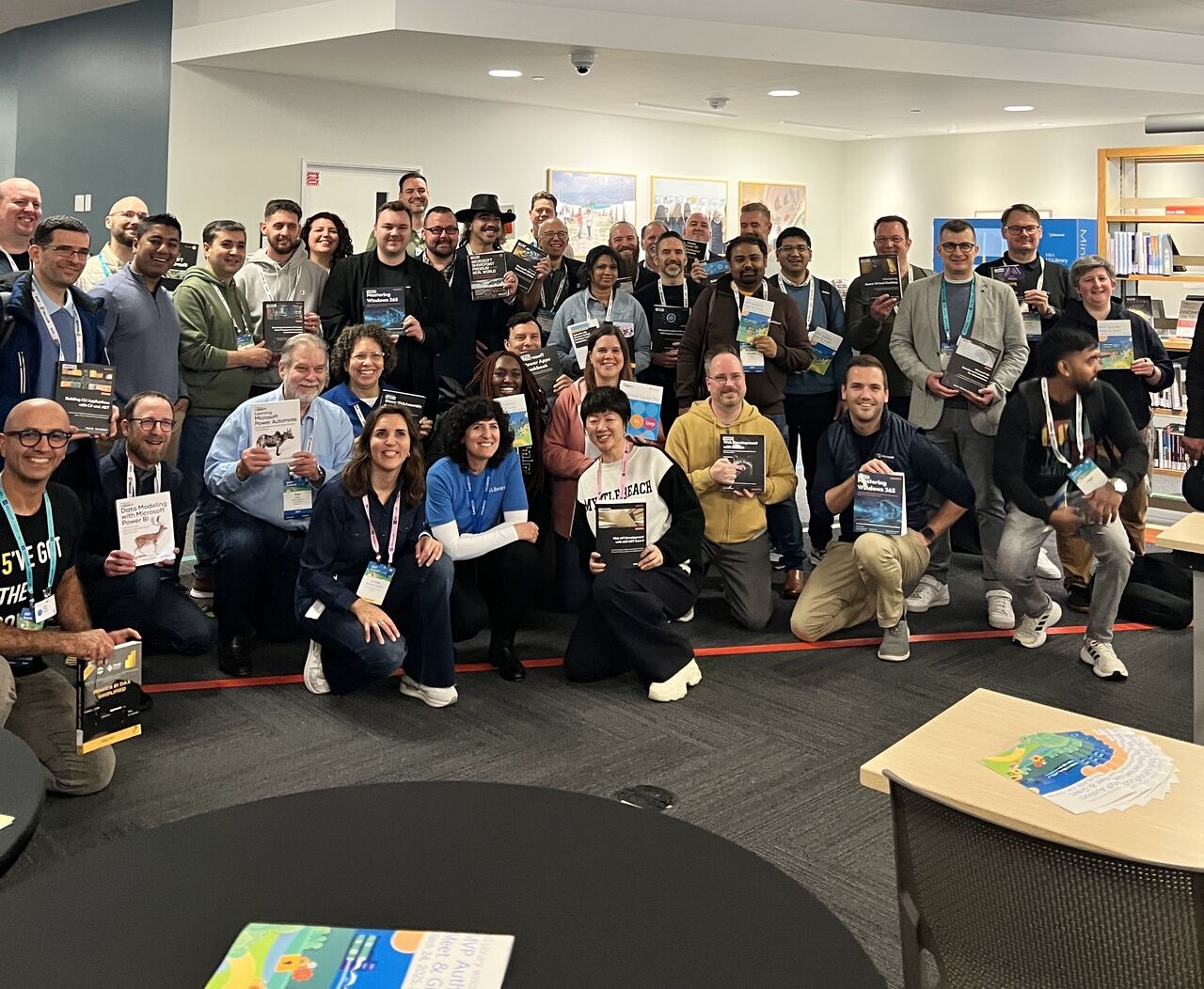 Group holding books at tech event